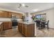Modern kitchen featuring stainless steel appliances, wooden cabinetry, and a dining area at 10923 E Flower Ave, Mesa, AZ 85208