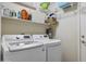 The laundry room features shelving and a stacked washer and dryer at 10923 E Flower Ave, Mesa, AZ 85208