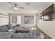 Cozy living room with a large sectional sofa, sliding glass door, and a wall-mounted television at 10923 E Flower Ave, Mesa, AZ 85208