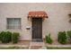 Charming front door with a wrought iron security gate and red tiled awning at 1208 E Lawrence Ln, Phoenix, AZ 85020