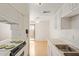 Bright kitchen with white cabinetry and appliances, adjacent to a casual dining area at 1208 E Lawrence Ln, Phoenix, AZ 85020