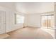 Bright living room with a large window and sliding doors to the patio at 1208 E Lawrence Ln, Phoenix, AZ 85020