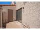 Enclosed patio with stucco walls, a sliding glass door, and an exterior door at 1208 E Lawrence Ln, Phoenix, AZ 85020