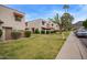Exterior view of well-maintained homes, green lawns, mature trees, and a neighborhood street at 1208 E Lawrence Ln, Phoenix, AZ 85020