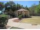 Charming gazebo in a green space with mature trees, offering a relaxing outdoor area at 12221 W Bell Rd # 209, Surprise, AZ 85378