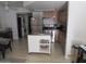Cozy kitchen features stainless steel appliances, wooden cabinets, and a convenient island with rolling wheels at 12221 W Bell Rd # 209, Surprise, AZ 85378
