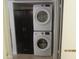 Convenient in-unit stacked washer and dryer near a black cabinet at 12221 W Bell Rd # 209, Surprise, AZ 85378