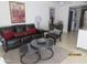 Inviting living room featuring a leather couch, layered tables, and decorative artwork at 12221 W Bell Rd # 209, Surprise, AZ 85378