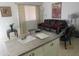 Inviting living room with black leather couch and bullfighting poster at 12221 W Bell Rd # 209, Surprise, AZ 85378