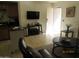 Open living area featuring tile floors, neutral paint, and a breakfast bar at 12221 W Bell Rd # 209, Surprise, AZ 85378