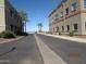 Wide street with well-maintained buildings and palm trees, creating a pleasant atmosphere at 12221 W Bell Rd # 209, Surprise, AZ 85378