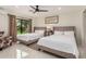 Spacious bedroom featuring two beds, ensuite bathroom and a ceiling fan at 12821 N 67Th St, Scottsdale, AZ 85254