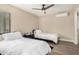 Bright bedroom with two twin beds, ceiling fan, and a mini-split AC unit at 12821 N 67Th St, Scottsdale, AZ 85254
