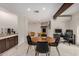 Open concept dining area with marble floors, wood table, and view to living room at 12821 N 67Th St, Scottsdale, AZ 85254