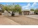 Single story house with white walls, gravel front yard, and green leafy tree at 12821 N 67Th St, Scottsdale, AZ 85254