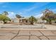 Single story house with white walls, decorative rock feature, and palm tree in front yard at 12821 N 67Th St, Scottsdale, AZ 85254