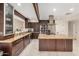 Gourmet kitchen features stainless steel appliances, granite countertops and custom cabinetry at 12821 N 67Th St, Scottsdale, AZ 85254