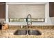 Close up of the kitchen sink with a stainless faucet and granite countertops at 12821 N 67Th St, Scottsdale, AZ 85254