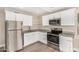 Bright kitchen showcasing stainless steel appliances, granite countertops, and white cabinets at 12821 N 67Th St, Scottsdale, AZ 85254