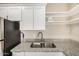 Kitchen area featuring a stainless steel sink, granite countertops, and white cabinetry at 12821 N 67Th St, Scottsdale, AZ 85254