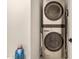 Convenient laundry room featuring a modern, stacked washer and dryer unit at 12821 N 67Th St, Scottsdale, AZ 85254