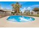 Inviting backyard pool with a safety fence, complemented by mature trees and landscaping at 12821 N 67Th St, Scottsdale, AZ 85254