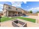 Expansive backyard featuring a pool, a fire pit, artificial grass, and covered patio perfect for outdoor living at 13304 W Stella Ln, Litchfield Park, AZ 85340