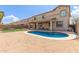 Stunning backyard showcasing a pool, covered patio, and ample space for entertaining Gathering and friends at 13304 W Stella Ln, Litchfield Park, AZ 85340