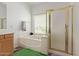 Bright bathroom featuring a bathtub, a shower, and wood floors at 13304 W Stella Ln, Litchfield Park, AZ 85340