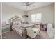 Bedroom featuring a bed, a ceiling fan, and a window at 13304 W Stella Ln, Litchfield Park, AZ 85340