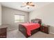Bedroom featuring a bed, a ceiling fan, and a window at 13304 W Stella Ln, Litchfield Park, AZ 85340