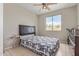 Bedroom featuring a ceiling fan, a window with a view, tile floors, and a bed at 13304 W Stella Ln, Litchfield Park, AZ 85340