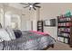 Bedroom featuring a bed, bookshelves, a television, and an ensuite bath at 13304 W Stella Ln, Litchfield Park, AZ 85340