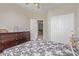 Bedroom featuring a ceiling fan, closet, door to another room, and a dresser at 13304 W Stella Ln, Litchfield Park, AZ 85340