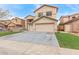 Charming two-story home featuring a 2-car garage, low maintenance landscaping, and neutral color palette at 13304 W Stella Ln, Litchfield Park, AZ 85340