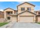Charming two-story home featuring a 2-car garage, low maintenance landscaping, and neutral color palette at 13304 W Stella Ln, Litchfield Park, AZ 85340