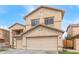 Charming two-story home featuring a 2-car garage, low maintenance landscaping, and neutral color palette at 13304 W Stella Ln, Litchfield Park, AZ 85340