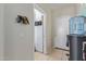 Hallway near a utility room, showing access to laundry facilities and storage space at 13304 W Stella Ln, Litchfield Park, AZ 85340