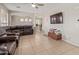 Spacious living room with tile flooring, ceiling fan, and ample natural light at 13304 W Stella Ln, Litchfield Park, AZ 85340