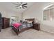 Serene main bedroom with neutral tones, carpet floors, and large windows at 13304 W Stella Ln, Litchfield Park, AZ 85340