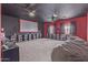 Spacious entertainment room featuring a large screen, built-in shelving, and a comfortable beanbag chair at 13304 W Stella Ln, Litchfield Park, AZ 85340