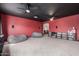 Spacious entertainment room featuring rows of built-in shelving, a projector, beanbag chairs at 13304 W Stella Ln, Litchfield Park, AZ 85340