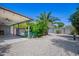 Spacious backyard with a covered patio, pool area and low maintenance desert landscaping at 1334 W Sells Dr, Phoenix, AZ 85013