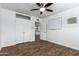 Bedroom featuring wood-look floors, a closet, and a pass-through to another room at 1334 W Sells Dr, Phoenix, AZ 85013