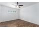 Empty bedroom featuring wood-look floors, a ceiling fan, and a window at 1334 W Sells Dr, Phoenix, AZ 85013