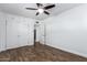 Bedroom with faux-wood floors, overhead fan, built-in cabinets and closet at 1334 W Sells Dr, Phoenix, AZ 85013