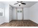 Bedroom with wood-look floors, ceiling fan, and built-in storage above a closet and by a window at 1334 W Sells Dr, Phoenix, AZ 85013