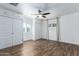 Bedroom with wood-look floors, ceiling fan, and built-in storage above closets and by window at 1334 W Sells Dr, Phoenix, AZ 85013