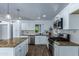 Modern kitchen with white cabinets, granite countertops, and stainless steel appliances at 1334 W Sells Dr, Phoenix, AZ 85013