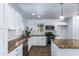 Bright kitchen featuring granite counters, subway tile backsplash, white cabinetry, and stainless appliances at 1334 W Sells Dr, Phoenix, AZ 85013